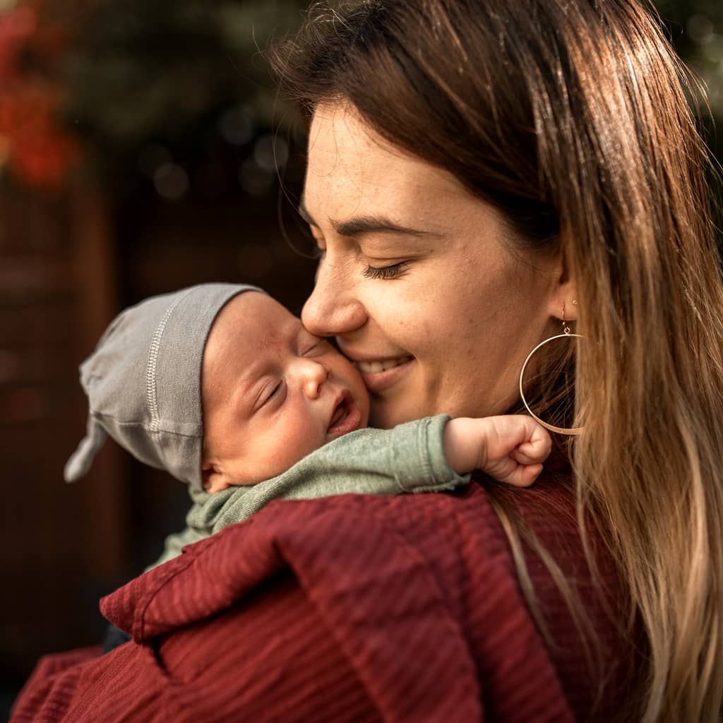 A Newborn and Mother Before Photo Background Editing Services